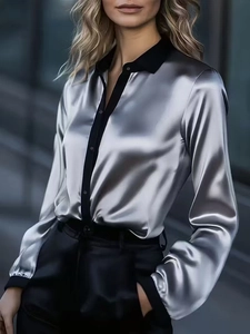 Detail of silver satin shirt with black contrast collar and cuffs on outdoor model