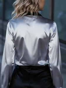 Rear view of silver satin long sleeve shirt with elegant sheen and black collar detail