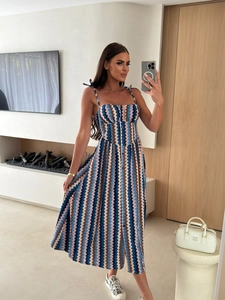Detail of summer strapless maxi dress featuring chevron print and front button closure