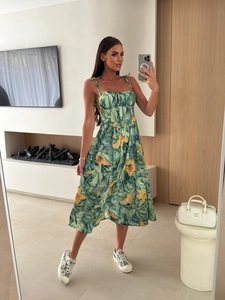 Detail of a tropical palm leaf print summer dress with button-up front and spaghetti straps