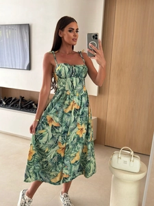 Detail of tropical print maxi dress featuring bow shoulder straps and front button closure