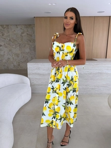 Detail of summer dress featuring lemon print, front buttons, and waist tie design