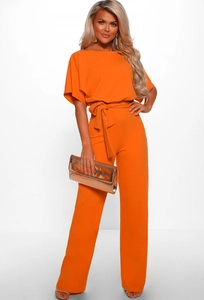 Detail of a bright orange off-shoulder jumpsuit with a waist tie and short sleeves