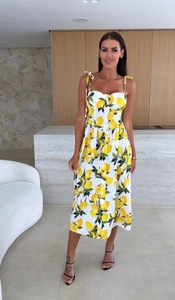 Detail of yellow lemon print on white summer dress with bow straps and button-up front