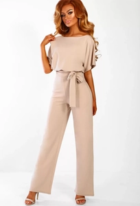 Detail of elegant beige off-shoulder jumpsuit with waist tie and wide leg silhouette
