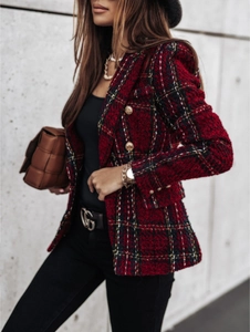 Detail of red and black plaid tweed blazer featuring decorative golden embossed buttons