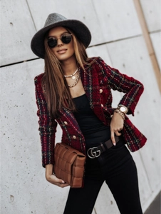 Detail of red and blue plaid tweed blazer featuring embossed gold buttons and classic lapel
