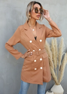 Detail view of caramel double-breasted blazer with white buttons and matching waist belt