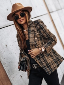 Detail of plaid tweed jacket featuring vintage metal buttons and structured shoulders