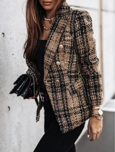 Close-up of brown tweed plaid blazer featuring embossed gold metal buttons and texture