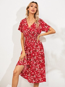 Close-up of deep V-neck and elastic waist detail on a red floral summer dress