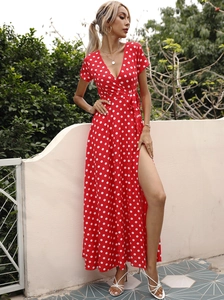 Details des roten Polka-Dot-Kleides mit tiefem V-Ausschnitt, Gürtel und Seitenschlitz