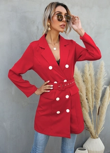 Detail of red longline blazer with double-breasted white buttons and matching waist belt