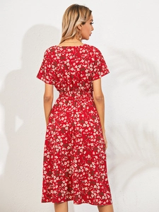 Detail view of the back of a red floral midi dress featuring elastic waist and short sleeves