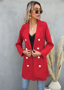 Close-up of red longline double-breasted blazer with classic white buttons and notched lapel