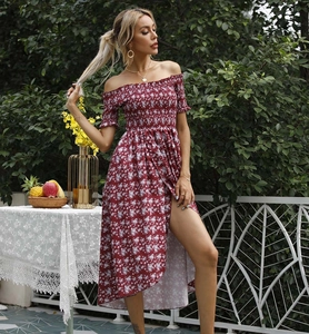 Detail of smocked waist and delicate floral print on a red off-shoulder maxi dress