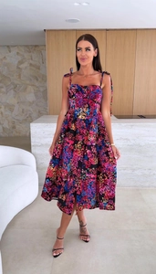 Detail of floral A-line midi dress featuring tie-up straps and vibrant flower pattern