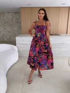 Detail of floral print pattern on a slim fit summer midi dress with a front leg slit