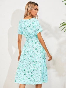 Detail view of the floral print pattern and elastic high waist on this light blue summer dress