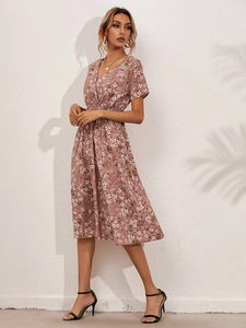 Close-up of floral summer dress featuring V-neck design and delicate print texture