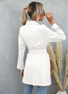 Detail view of white longline blazer jacket with adjustable waist belt and lapel collar