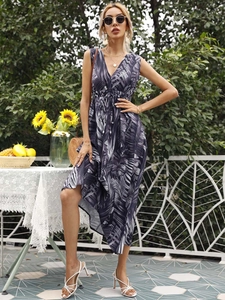 Detail of tropical palm leaf print on V-neck sleeveless dress with drawstring waist