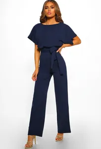 Detail of navy blue short sleeve jumpsuit showing waist tie bow and fabric texture