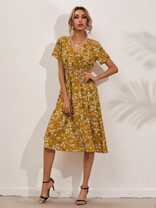 Detailed full-length shot of a yellow floral V-neck midi dress with elastic waist
