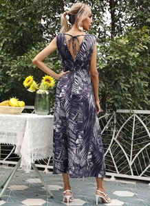 Detail of tropical palm leaf print maxi dress featuring back cut-out and tie-up design