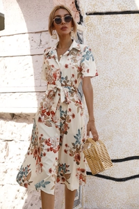Close-up of summer floral midi dress with button front and adjustable waist tie