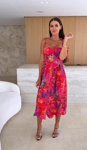 Detail of red floral midi dress with tie-shoulder straps and front button decoration