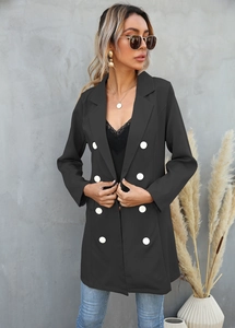 Detail of black double-breasted long blazer with six contrasting white buttons on front