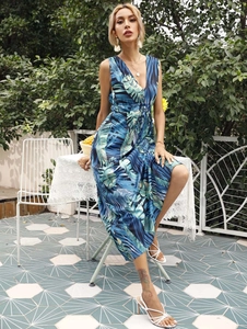 Detailed close-up of a deep V-neck sleeveless long dress with tropical plant leaf print