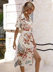 Detail of short-sleeved floral shirt dress with waist tie and side slits for summer