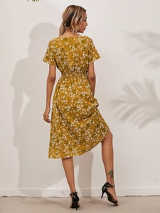 Back view of a yellow floral midi dress with elastic high waist and airy A-line skirt