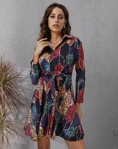 Detail of colorful geometric leopard print long sleeve shirt dress with waist tie belt