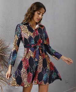 Detail of long-sleeve dress featuring geometric prints, leopard textures, and waist tie