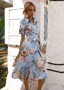 Detailed view of short-sleeved floral shirt dress with waist tie and front buttons