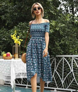 Detail of floral off-shoulder dress with elastic smocking in a vacation garden setting