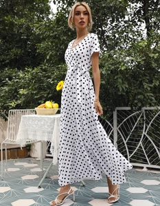 Detail eines weißen Polka-Dot-Chiffonkleids mit Wickel-V-Ausschnitt und Taillenschnürung