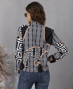 Detail view of women's autumn jacket featuring black and white geometric labyrinth patterns