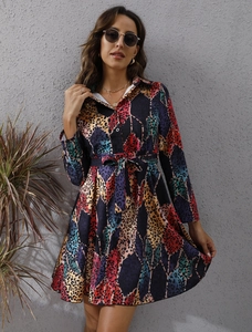 Detail of colorful geometric leopard print pattern on a long sleeve shirt dress