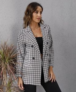 Detail of a houndstooth double-breasted blazer with classic lapels and black buttons