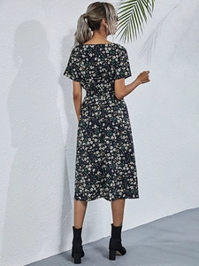 Back view of a summer floral midi dress with short sleeves and white flower print