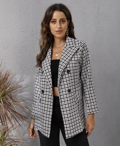 Detail of the houndstooth pattern and double-breasted buttons on a slim blazer