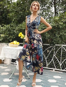 Detail of elegant V-neck sleeveless maxi dress with vibrant tropical floral pattern