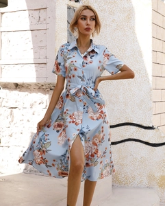 Detail of short sleeve floral shirt dress with waist tie and button-up front closure
