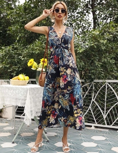 Detail of the deep V-neck and tropical floral print on a sleeveless maxi dress