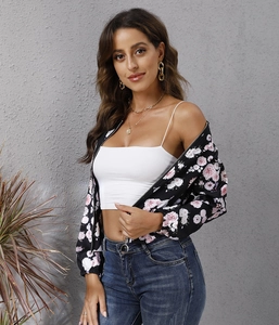 Detailed shot of women's floral bomber jacket with zip-up front and elastic cuffs