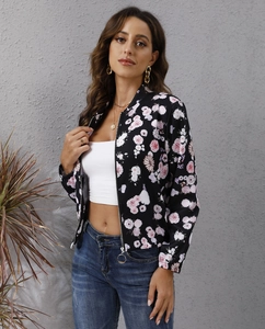 Detail of floral printed bomber jacket with zip closure on a lifestyle fashion model
